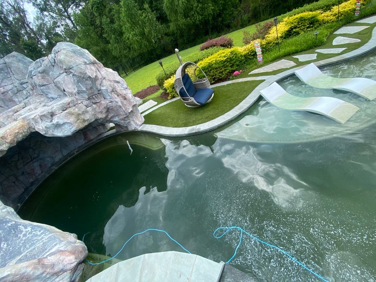 Grotto pool before cleaning, green water